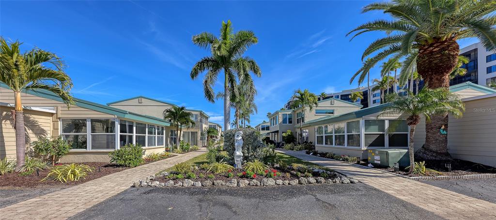 5860 Midnight Pass Road, Unit 40 Sarasota, FL 34242 - Photo 27 of 37 a front view of a house with a tree