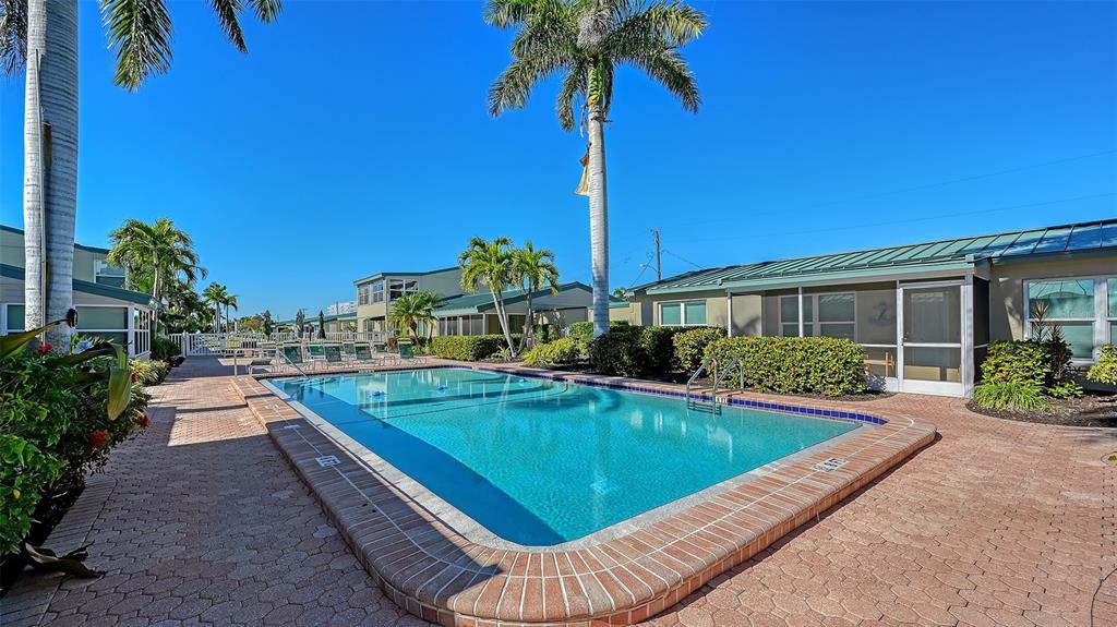 5860 Midnight Pass Road, Unit 40 Sarasota, FL 34242 - Photo 31 of 37 a view of a house with swimming pool and sitting area