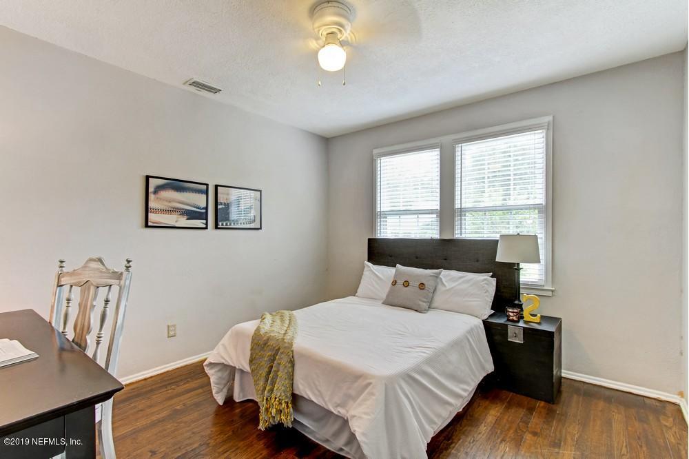 3752 Lilly Road North Jacksonville, FL 32207 - Photo 19 of 28 a bedroom with a bed and wooden floor