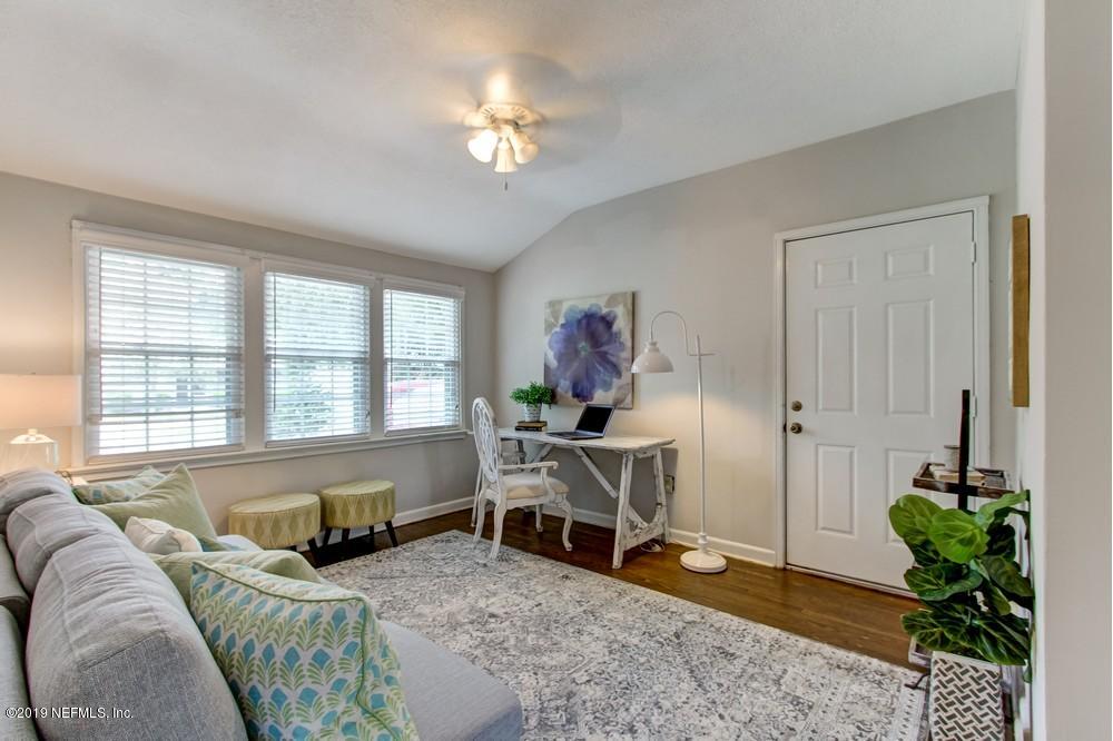 3752 Lilly Road North Jacksonville, FL 32207 - Photo 9 of 28 a bedroom with a bed and a chandelier