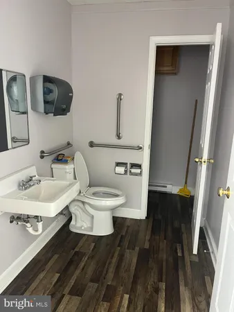 a white toilet sitting next to a bathroom sink