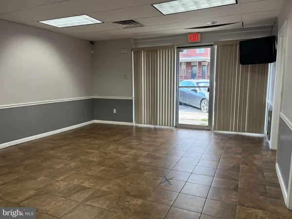 a view of an empty room and a window