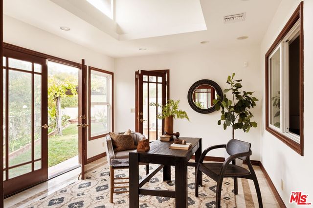 a view of a dining room with furniture and a large window