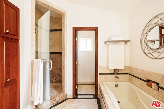 a bathroom with a tub and a shower