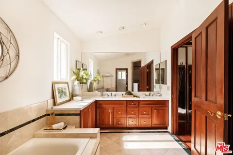 a living room with furniture a rug and white doors