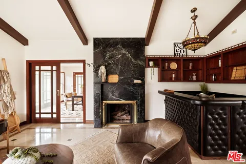 a living room with furniture a fireplace and a window