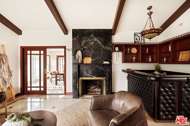 a living room with furniture a fireplace and a window
