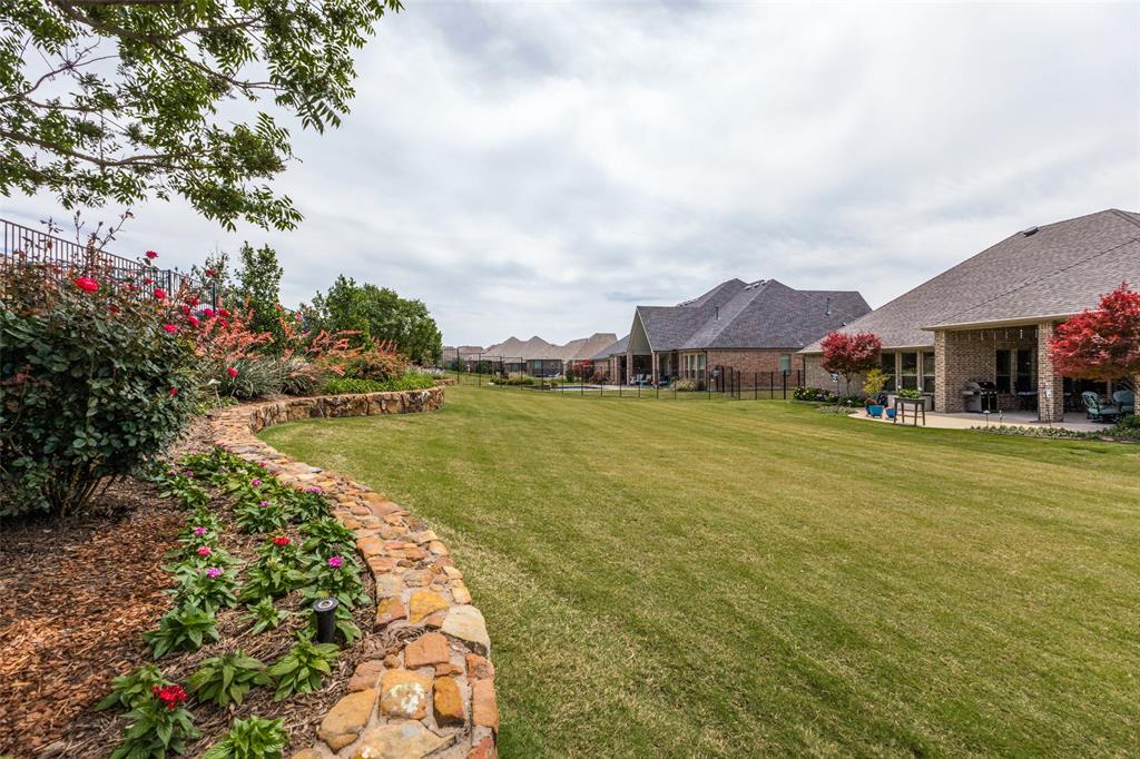 506 Life Spring Drive Rockwall, TX 75087 - Photo 33 of 36 a view of a lake with a house in the background