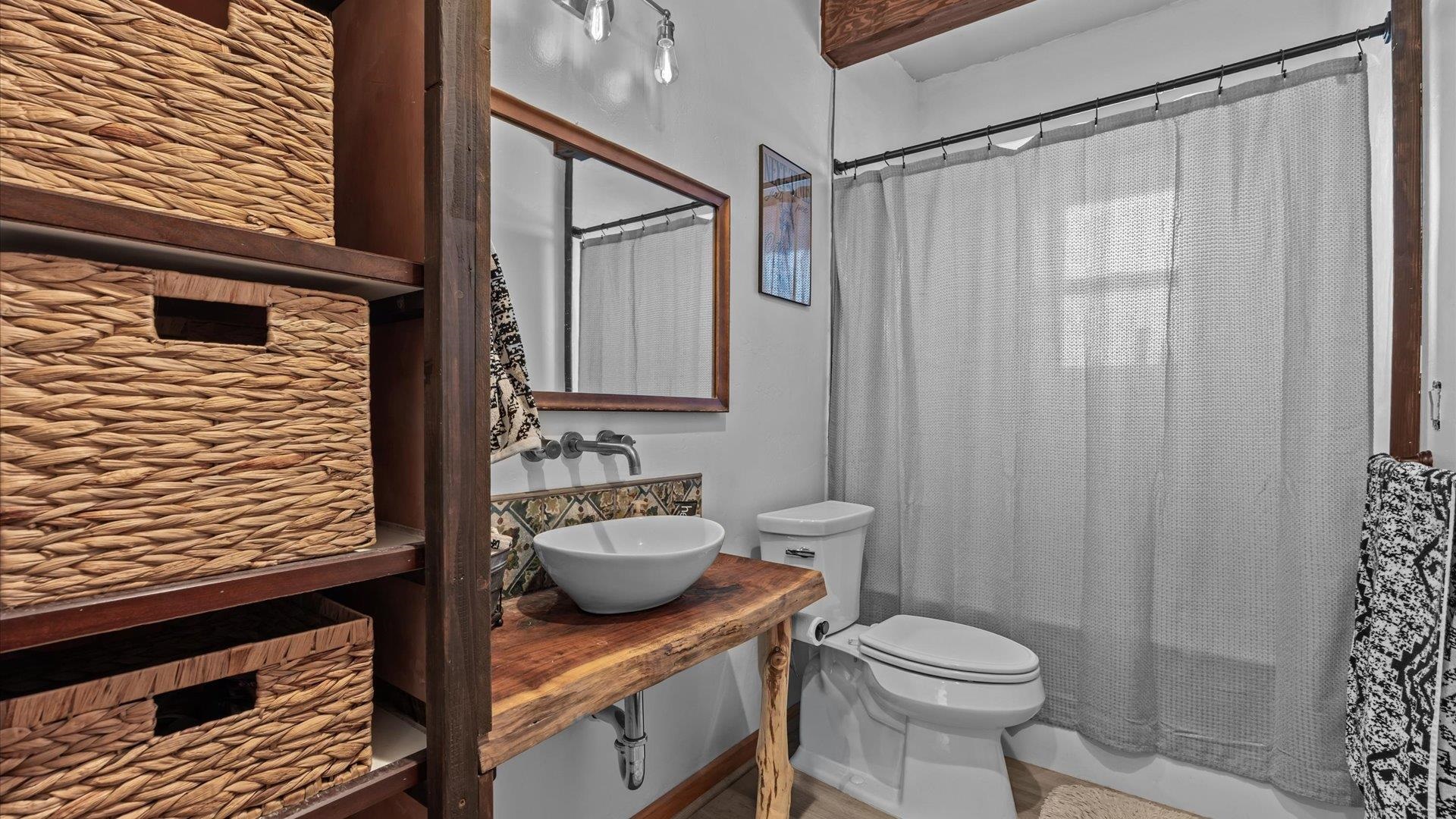 10795 52 52 1/2 Road Molina, CO 81646 - Photo 37 of 41 a bathroom with a granite countertop sink a toilet and shower curtain