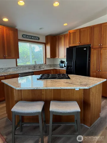 a kitchen with a table chairs sink refrigerator and microwave