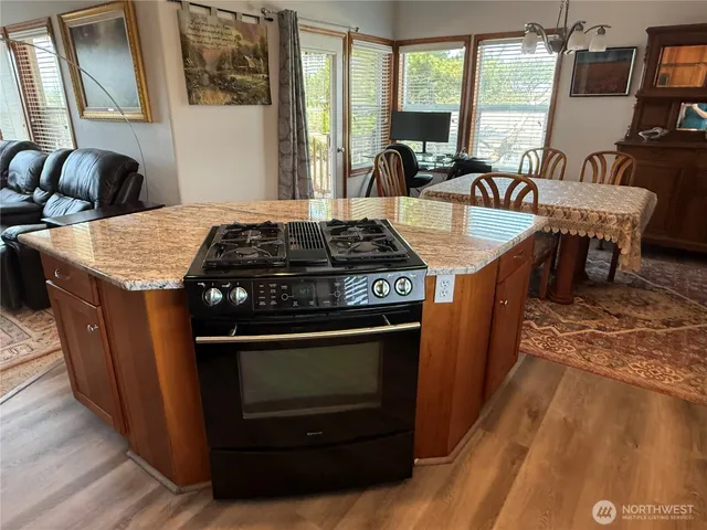 a kitchen with a stove and a dining table