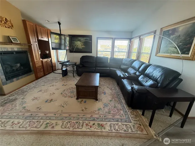 a living room with furniture fireplace and a flat screen tv