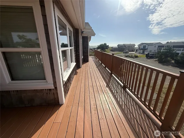 a view of balcony with wooden floor