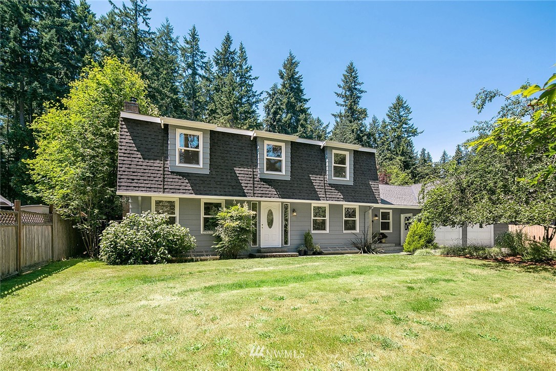 17905 Beall Road Southwest Vashon, WA 98070 - Photo 1 of 20 a front view of a house with a garden
