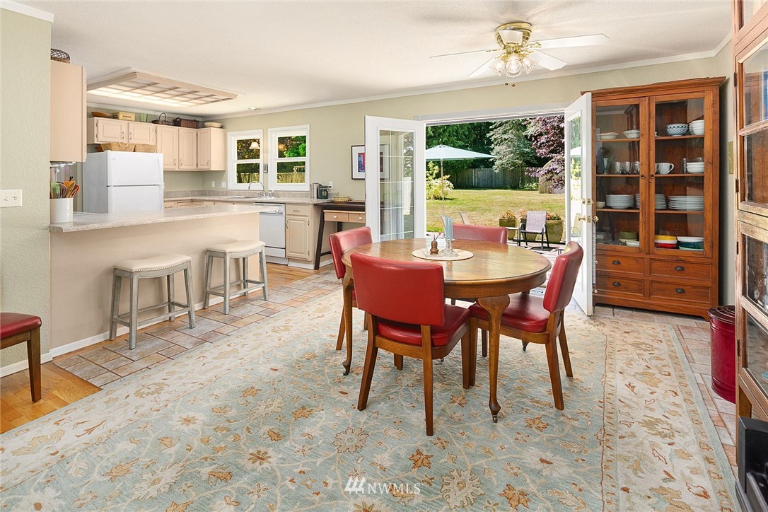 17905 Beall Road Southwest Vashon, WA 98070 - Photo 5 of 20 a dining room with furniture a floor to ceiling window and wooden floor