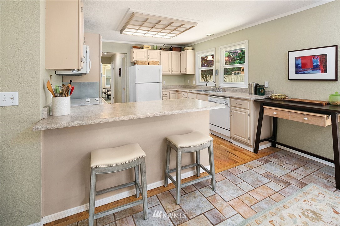 17905 Beall Road Southwest Vashon, WA 98070 - Photo 6 of 20 a kitchen with stainless steel appliances kitchen island granite countertop a sink and cabinets