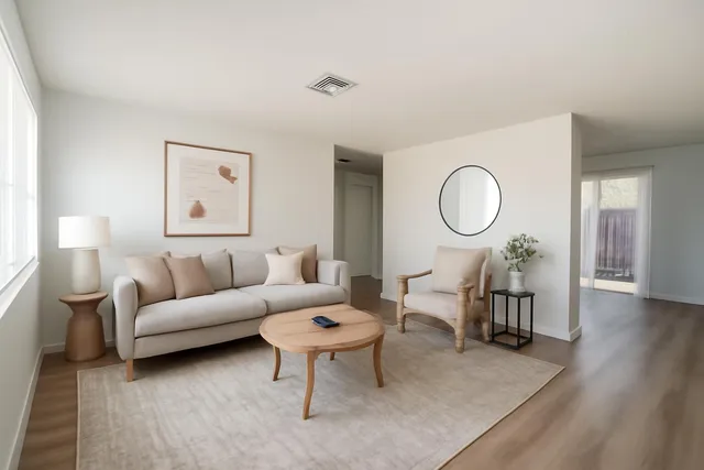 a living room with furniture a rug and a window