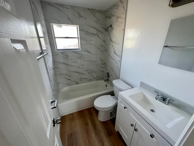 a bathroom with a sink toilet and shower