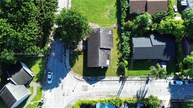 a view of a house with a yard and sitting area