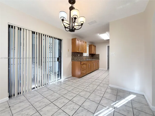 a view of a kitchen with granite countertop cabinets and stainless steel appliances