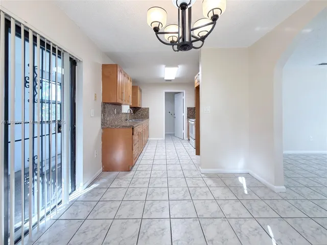 a view of a kitchen with a sink and cabinets