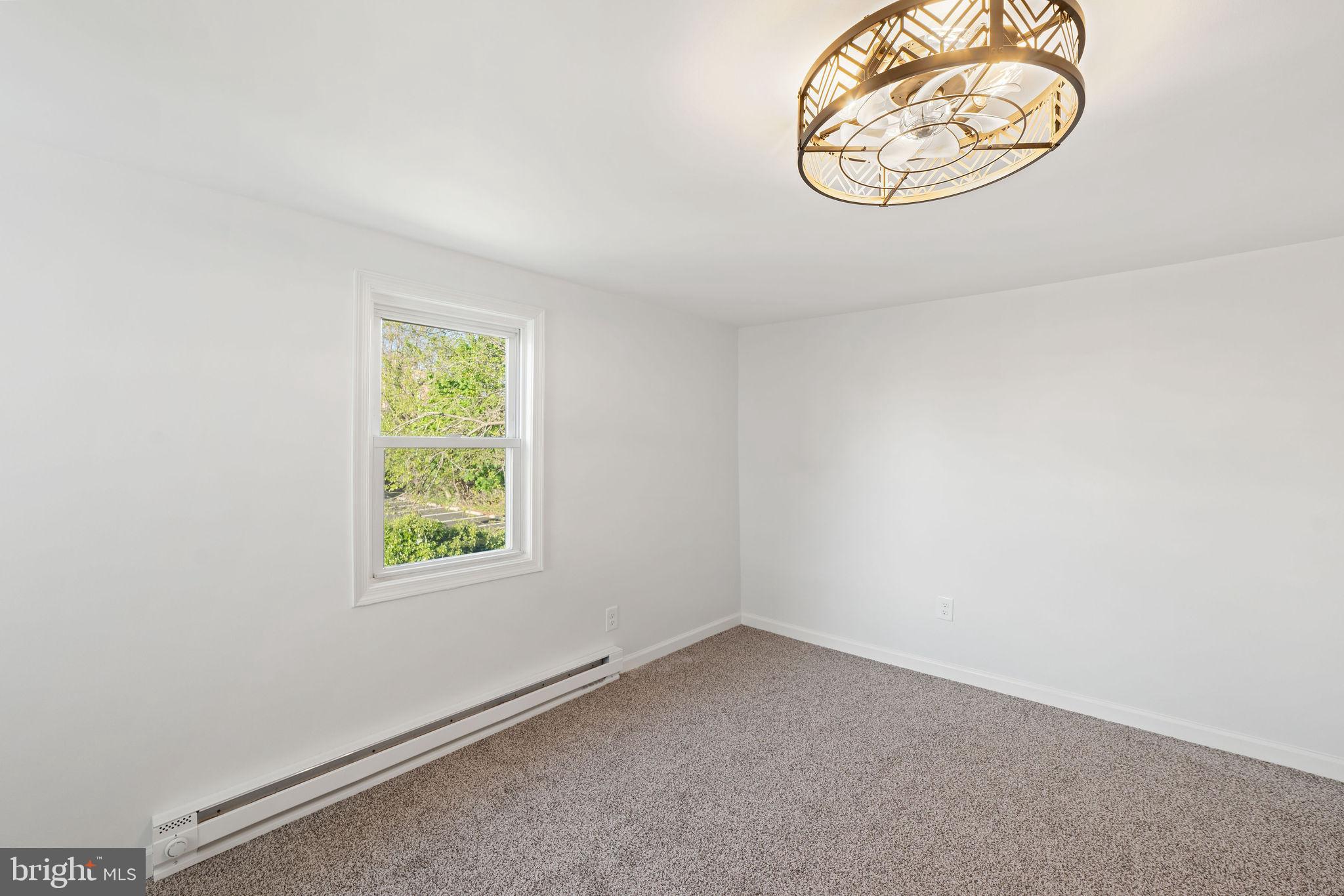 4 Walnut Street Salem, NJ 08079 - Photo 21 of 33 an empty room with a table and a window