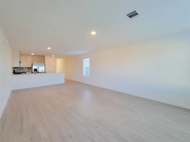 a view of a kitchen with a sink and a window