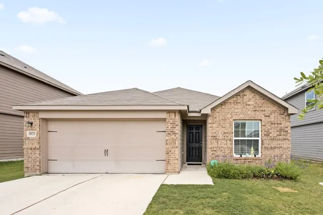 a front view of a house with garage
