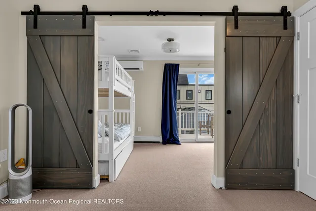 a bedroom with bed and a flat tv screen