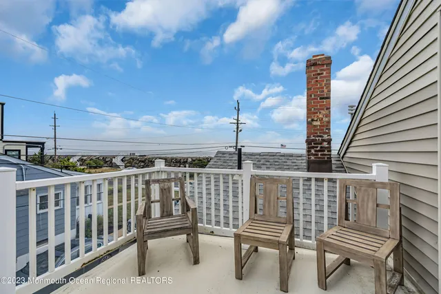 a view of a balcony with two chairs and a table