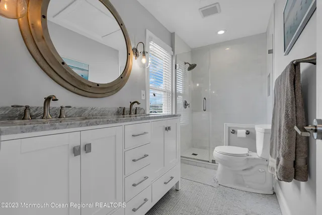 a bed sitting in a spacious bedroom next to a window