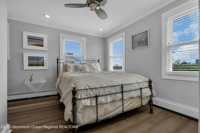 a bed sitting in a spacious bedroom next to a window