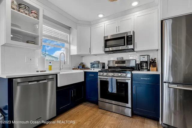 a kitchen with stainless steel appliances granite countertop a stove a refrigerator and a microwave