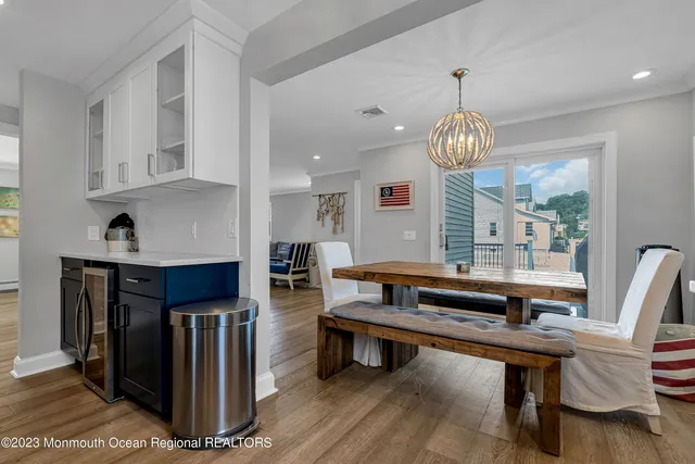 a living room with fireplace furniture and a chandelier