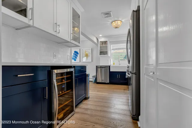 a view of a kitchen with wooden floor and cabinets