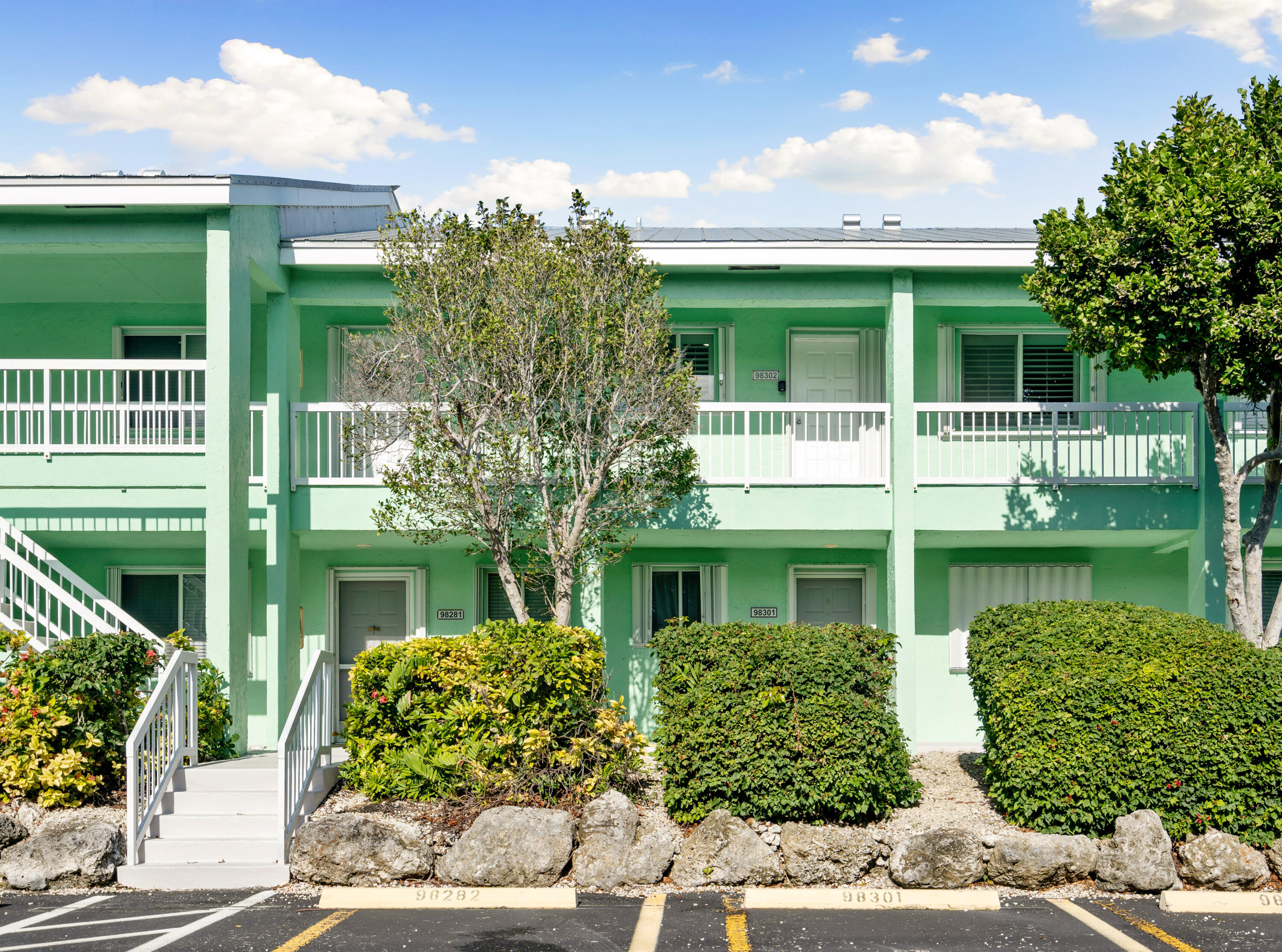 98302 Windward Avenue Key Largo, FL 33037 - Photo 16 of 35 a front view of a house with garden