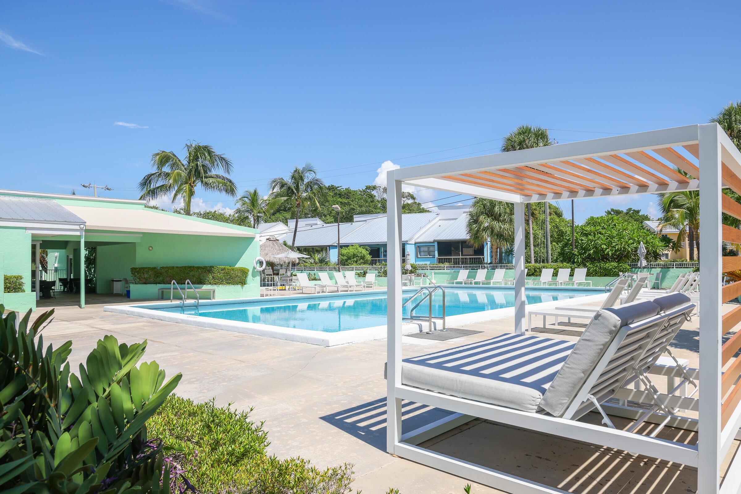 98302 Windward Avenue Key Largo, FL 33037 - Photo 24 of 35 a view of a patio with a table and chairs under an umbrella
