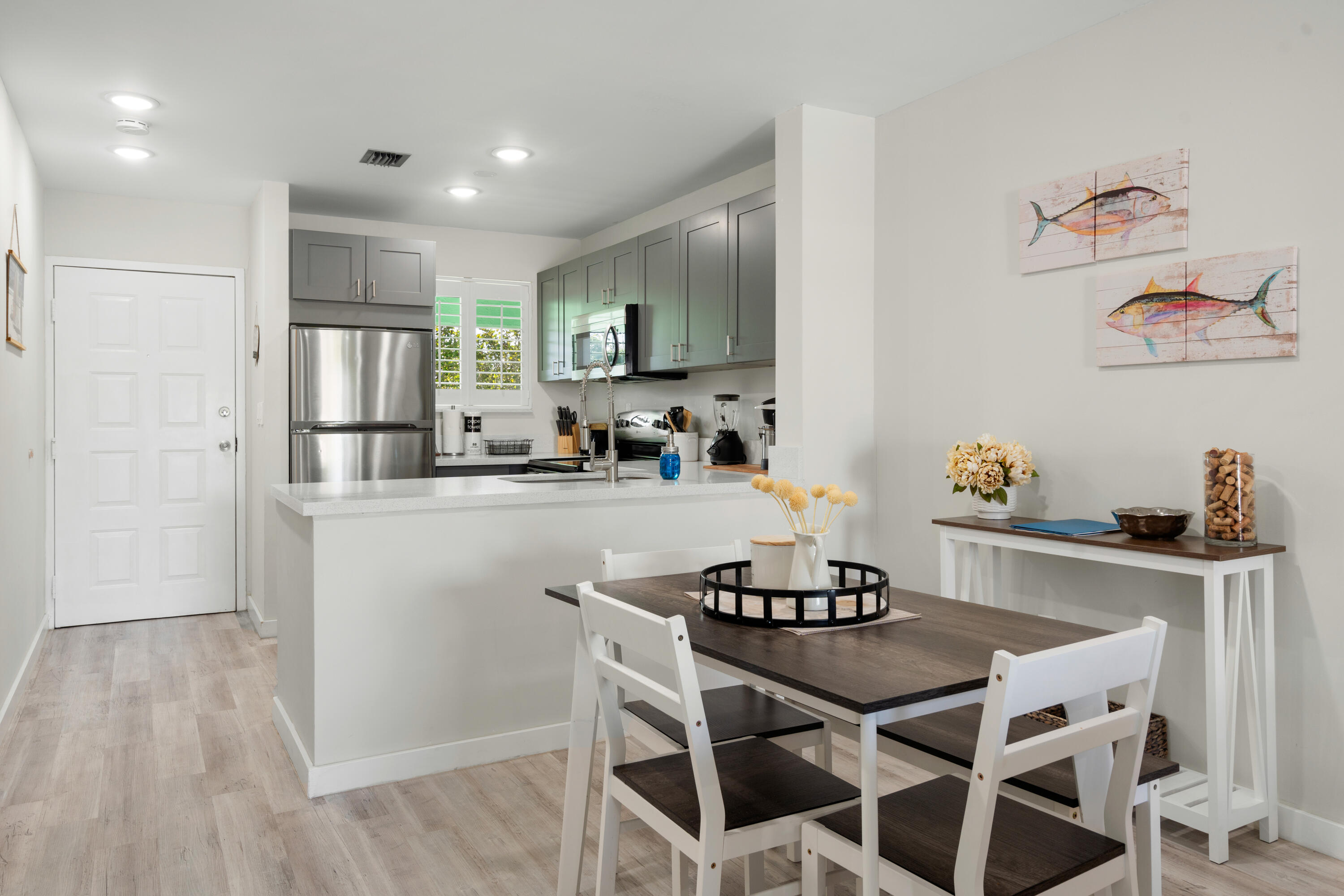 98302 Windward Avenue Key Largo, FL 33037 - Photo 3 of 35 a kitchen with stainless steel appliances granite countertop a dining table chairs refrigerator and sink