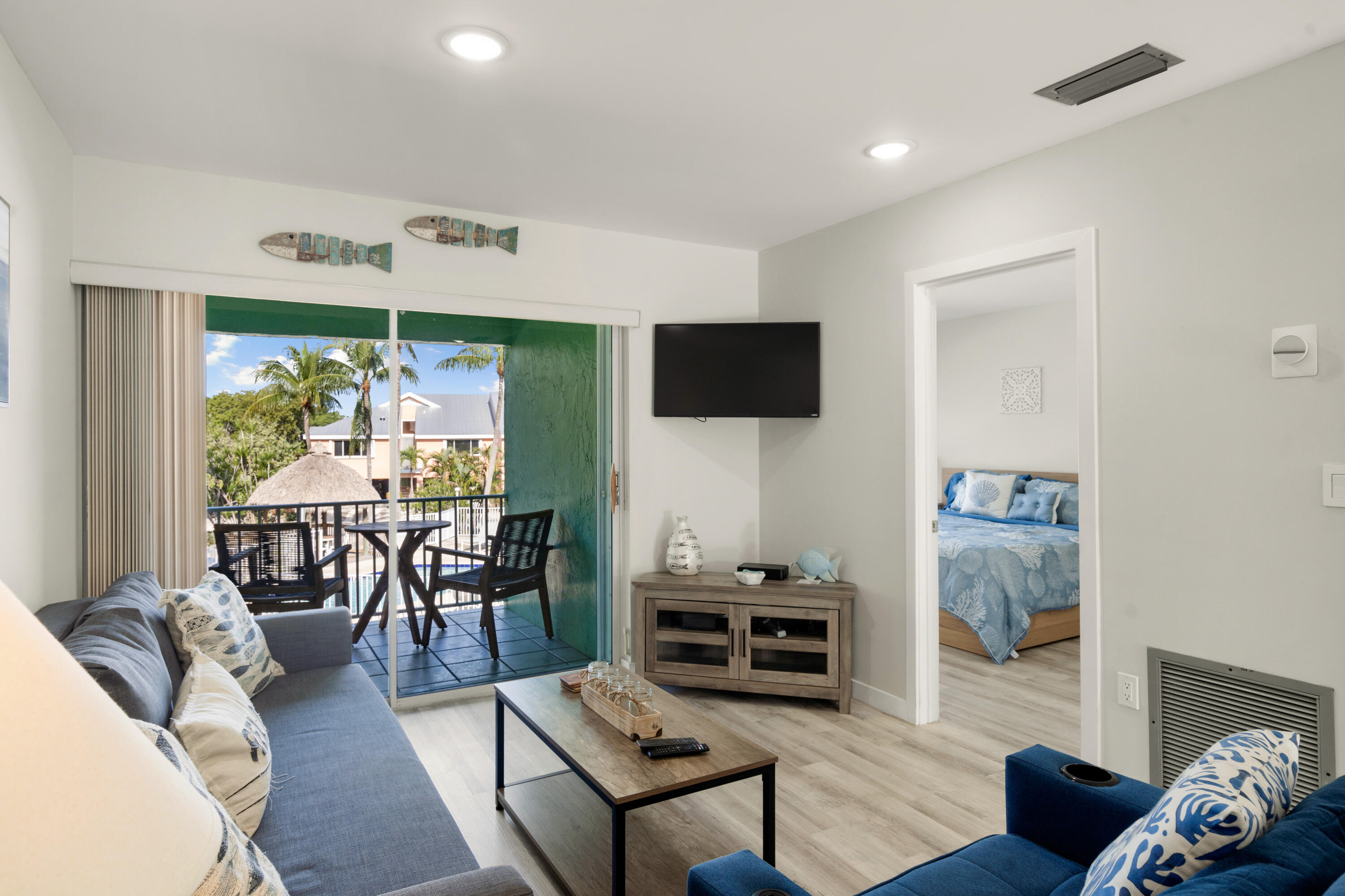 98302 Windward Avenue Key Largo, FL 33037 - Photo 5 of 35 a living room with furniture a rug and a flat screen tv