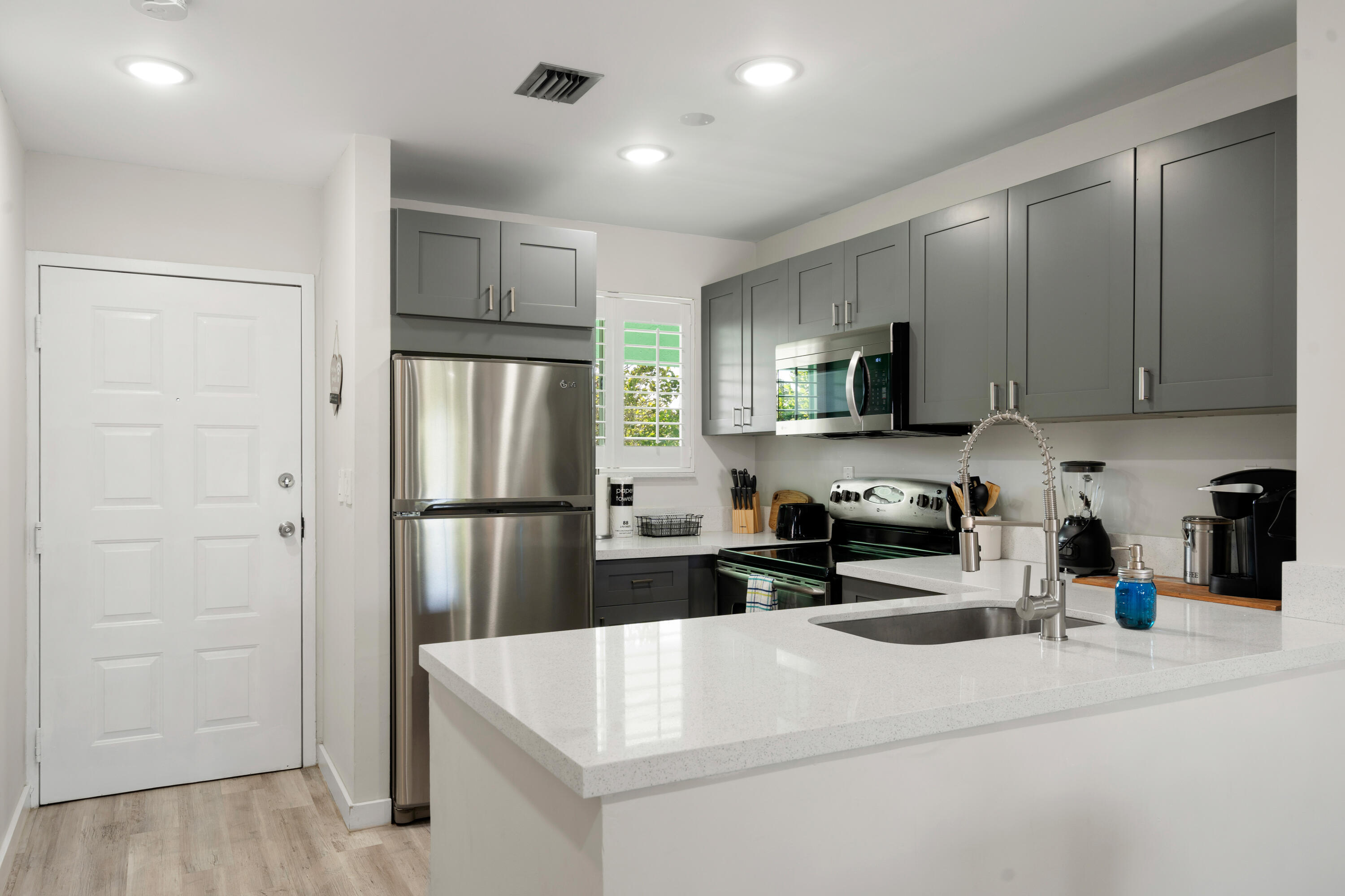 98302 Windward Avenue Key Largo, FL 33037 - Photo 8 of 35 a kitchen with a refrigerator a stove top oven a sink and dishwasher