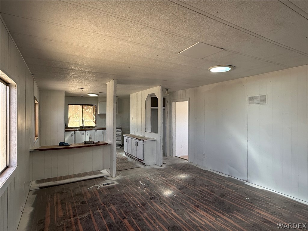 8051 7th Street Dolan Springs, AZ 86441 - Photo 26 of 65 a view of a hallway with wooden floor and a living room