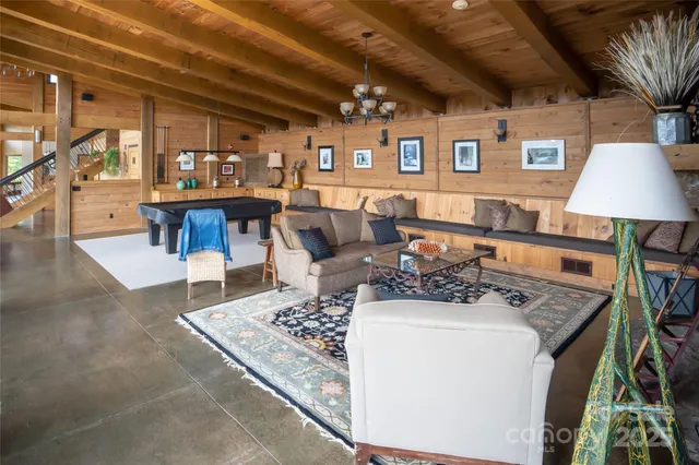 a living room with furniture and a floor to ceiling window