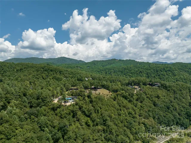 a view of a chair and table in backyard of the house