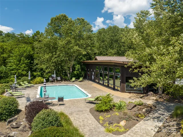 a view of a swimming pool with an outdoor seating area