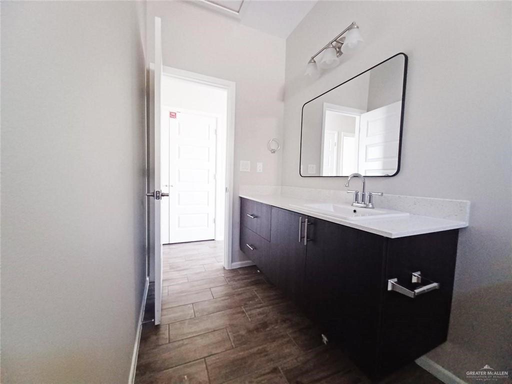 906 East Starr Road, Unit B Mercedes, TX 78570 - Photo 9 of 10 a bathroom with a sink and a mirror
