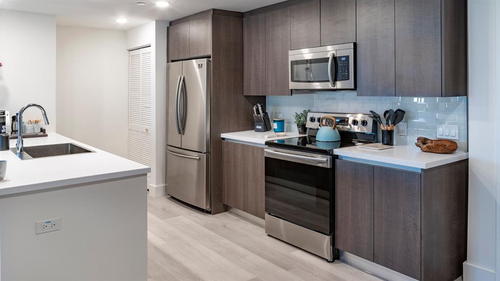 425-475 East Atlantic Boulevard, Unit 510 Pompano Beach, FL 33060 - Photo 22 of 35 a kitchen with a refrigerator sink and microwave