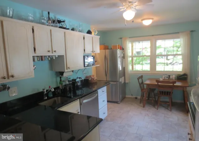 a kitchen with refrigerator and window
