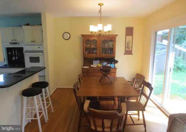 a view of a dining room with furniture and chandelier