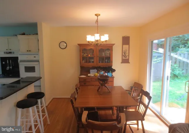a view of a dining room with furniture and chandelier