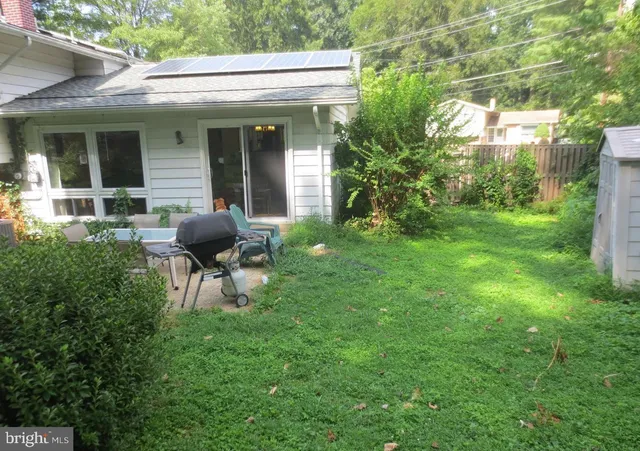 a view of a house with backyard sitting area and garden